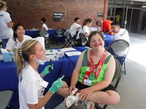 Student working with a Special Olympics athlete