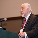 Dr. Carlos Salinas speaks from a podium.