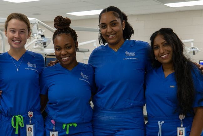 A group of smiling students at the MUSC College of Dental Medicine.