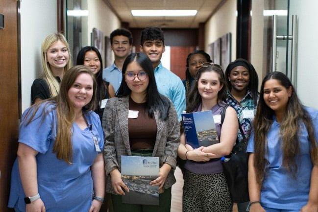 A group of smiling MUSC College of Dental Medicine students smiling.